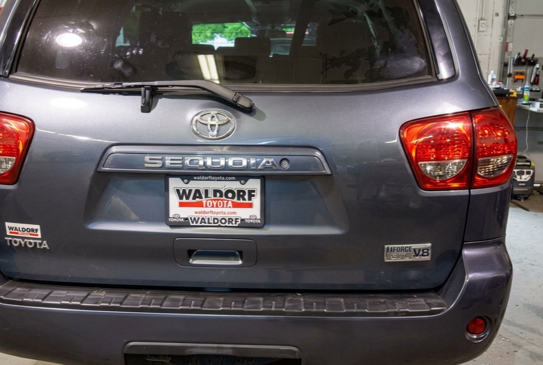 Dented rear quarter panel on a customer SUV in the shop
