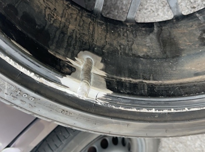 Cracked black alloy wheel