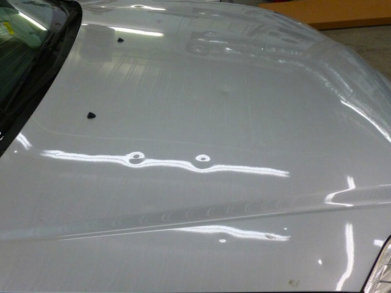 Hail-dented panel before paintless repair