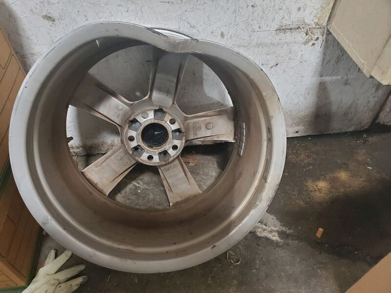 Bent five-spoke alloy wheel lip before straightening