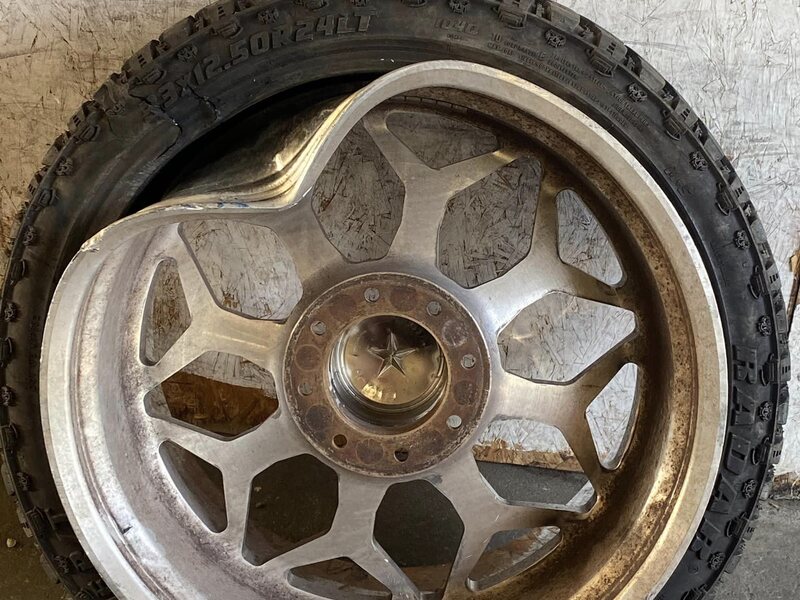 Bent chrome multi-spoke wheel before repair